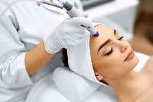 Face Skin Care. Close-up Of Woman Getting Facial Hydro Microdermabrasion Peeling Treatment At Cosmetic Beauty Spa Clinic. Hydra Vacuum Cleaner. Exfoliation, Rejuvenation And Hydratation. Cosmetology.