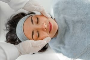 Happy woman receiving a beauty treatment