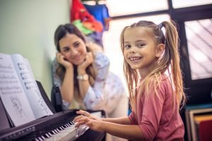 I love playing the piano. Child in music school.